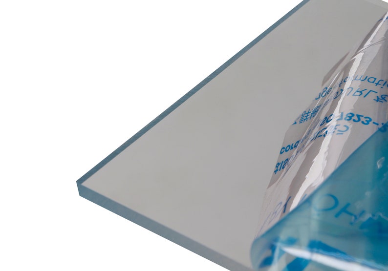 May include: A clear sheet of acrylic plastic with a blue protective film partially peeled back. The film has text in Japanese and English, including "Cold Side Up" and "1353-30C".
