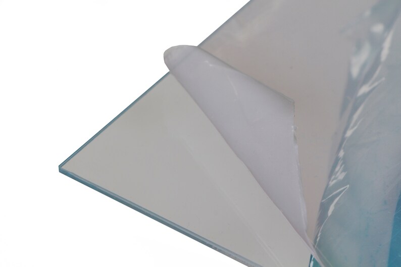 May include: A clear sheet of acrylic with a protective film on one side. The film is being peeled back to reveal the clear acrylic.