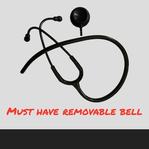 May include: Black stethoscope with a removable bell. The stethoscope is lying on a white background. The text "MUST HAVE REMOVABLE BELL" is visible below the stethoscope.