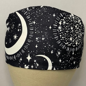 May include: Black scrub hat with a white crescent moon and stars pattern.