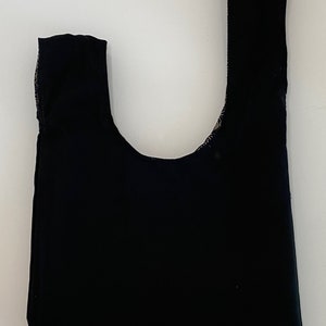 May include: A black fabric tote bag with a single handle.
