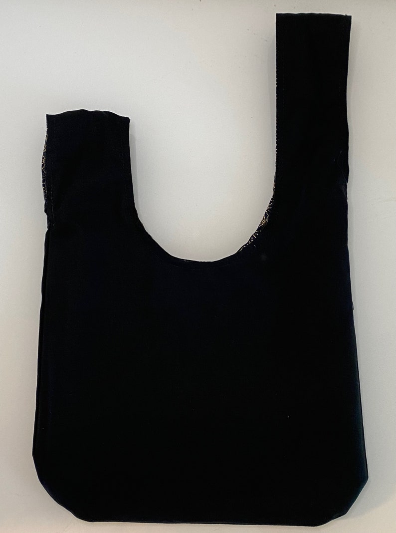 May include: A black fabric tote bag with a single handle.