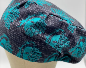 May include: A gray and teal scrub hat with a brick pattern and the text "Social Distancing and Wearing a Mask in Public Since 1978" repeated on the fabric.
