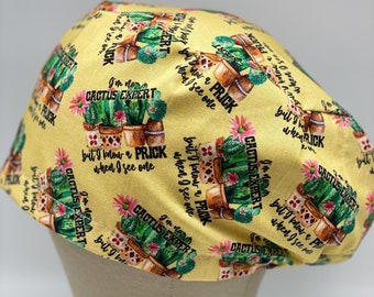 Puede incluir: Un gorro de quirófano de tela amarilla con un patrón repetido de cactus en maceta y el texto "No soy un experto en cactus, pero sé reconocer un pincho cuando veo uno."