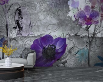 May include: A modern living room with a floral mural featuring large purple flowers and blue accents. A white sofa, round coffee table, and decorative vase with yellow flowers complete the scene. The floor is a dark gray, textured material.