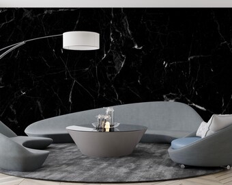 May include: A modern living room with a black marble wall, gray sofa, two gray armchairs, and a round coffee table. A silver arc lamp and a white lampshade hang above the seating area. The room is decorated with a gray rug.