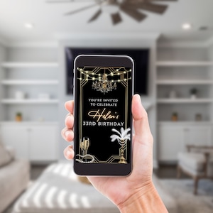 May include: A black and gold smartphone screen displaying a birthday invitation for Helen's 33rd birthday. The invitation features a gold chandelier, champagne flutes, and a feather boa.