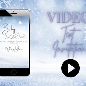 May include: A smartphone screen displaying a winter-themed baby shower invitation with the text "Baby It's Cold Outside" and "Please join us for a baby shower in honor of Whitney Shaw". The background is a snowy landscape with snowflakes falling. The text "VIDEO Text Invitation" is displayed above the phone screen with a play button icon.