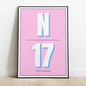May include: A pink and blue poster with the letter "N" and the number "17" in white with a blue outline. The text "TOTTENHAM" is at the bottom of the poster.