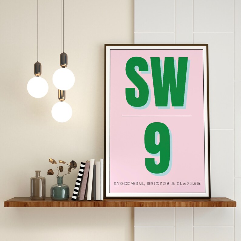 May include: A pink and green poster with the text "SW9" and the words "Stockwell, Brixton & Clapham" printed below.