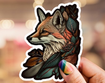 May include: A sticker featuring a detailed illustration of a fox's head with a colorful floral design. The fox has a reddish-brown coat and the flowers are in shades of blue, green, and orange.