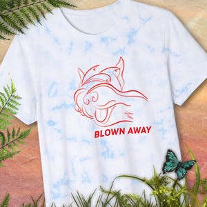 Blown Away Scottie - Blue and White Tie Dye Shirt. Illustration of orange-red Scottie Head with wind blowing through the beard. Image of t-shirt alone.