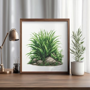 May include: A framed print featuring a detailed illustration of a lush green plant with long, slender leaves and smaller plants around a cluster of rocks. The artwork is in a brown wooden frame, displayed on a wooden surface.