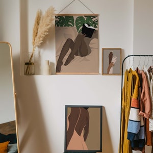 May include: Three framed illustrations of women in a minimalist style. The top illustration features a woman lying down reading a book. The middle illustration features a woman with her back to the viewer wearing a dress. The bottom illustration features two hands reaching towards each other.