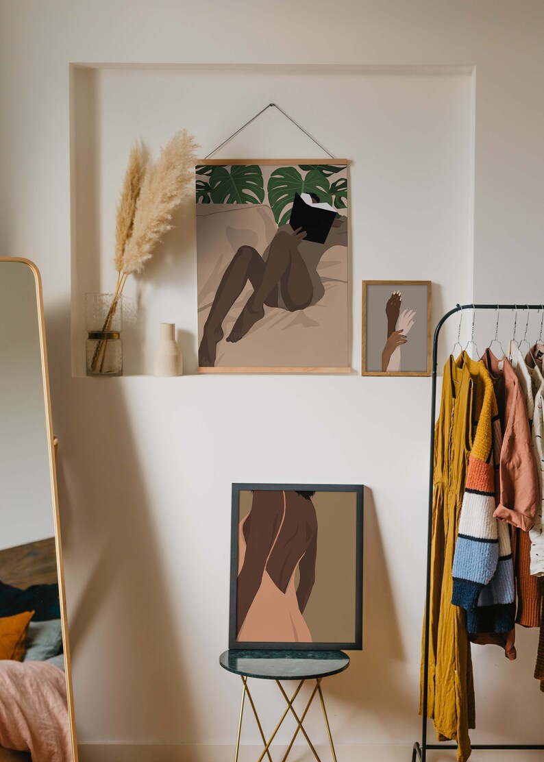 May include: Three framed illustrations of women in a minimalist style. The top illustration features a woman lying down reading a book. The middle illustration features a woman with her back to the viewer wearing a dress. The bottom illustration features two hands reaching towards each other.