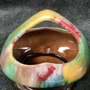 Vintage Czechoslovakian art pottery. Handled basket in multi colors.