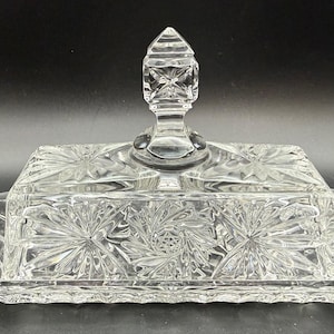 May include: A rustic wooden sign with the text "Welcome to our home" in white lettering. The sign features a distressed finish and a simple, inviting design, perfect for entryway decor.