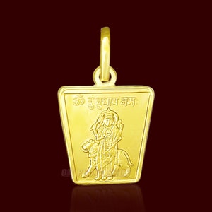 May include: A gold pendant featuring a deity with a lion, surrounded by a square frame with the text "Om  Bu  Bubhay  Nama:".
