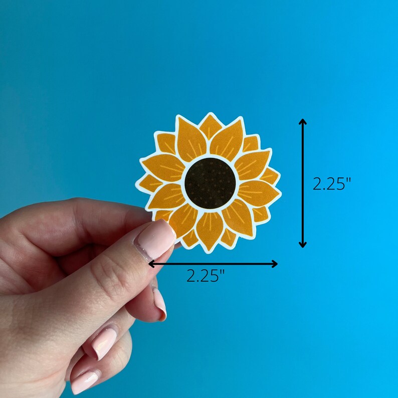 May include: A yellow sunflower sticker with a black center. The sticker is 2.25 inches wide and 2.25 inches tall.