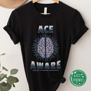 May include: Black t-shirt with the text "ACE AWARE" in white and blue with a brain graphic in the center. The text "ADVERSE CHILDHOOD EXPERIENCES" is below the graphic.