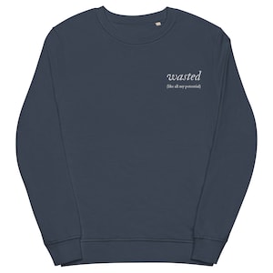 May include: A dark blue sweatshirt with the text "wasted (like all my potential)" printed in white on the front.