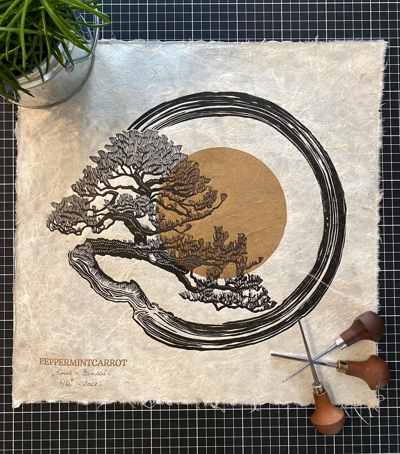 May include: A black and brown print of a bonsai tree with a circle around it on a white textured paper. The print is signed "PeppermintCarrot Emma - Bonsai - 6/60 - 2019".