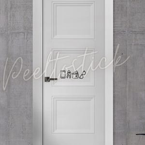 May include: A white door with a black door handle and a black and white sticker of a phone, keys, wallet, and glasses. The sticker is on the middle panel of the door.