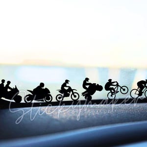 May include: Silhouette decals of people riding motorcycles and bicycles. The decals are black and are arranged in a line on a car's rear window.