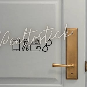 May include: A white door with a gold door handle and a black and white sticker with icons of a phone, keys, wallet, and glasses. The sticker says "Dealtostick".