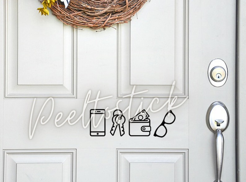 May include: A white door with a black vinyl decal of a phone, keys, wallet, and glasses. The decal says "Peelstick".
