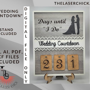 Puede incluir: Un letrero de cuenta atrás para bodas de madera con fondo gris y ribete de encaje blanco. El letrero presenta el texto "Días hasta "Yo quiero" Cuenta atrás de la boda" y una silueta de una novia y un novio. El letrero tiene tres bloques numerados que se pueden voltear para contar los días hasta la boda.