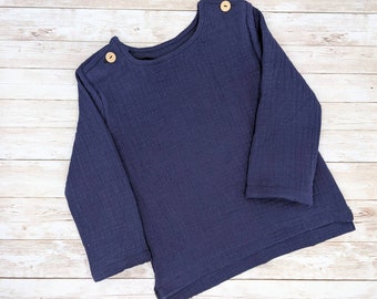 May include: A navy blue long-sleeved shirt with a relaxed fit and wooden button accents.