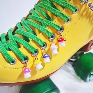 May include: Yellow roller skate with green laces and mushroom charms in pink, purple, yellow and red.
