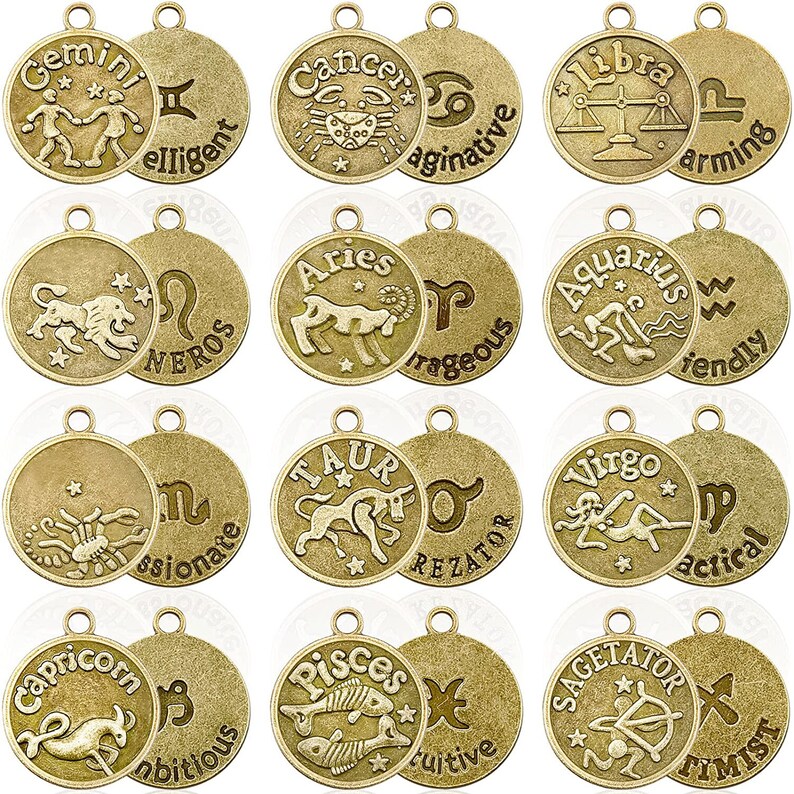 May include: Twelve gold-toned metal charms, each featuring a different zodiac sign and a descriptive word. The charms are round and have a loop at the top for hanging.