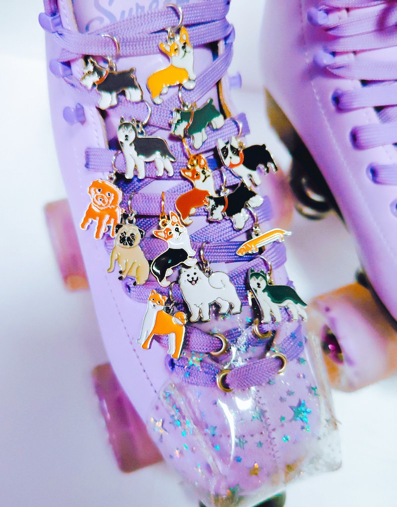 May include: Purple roller skates with a variety of dog charm shoe laces. The charms are in different breeds and colors.