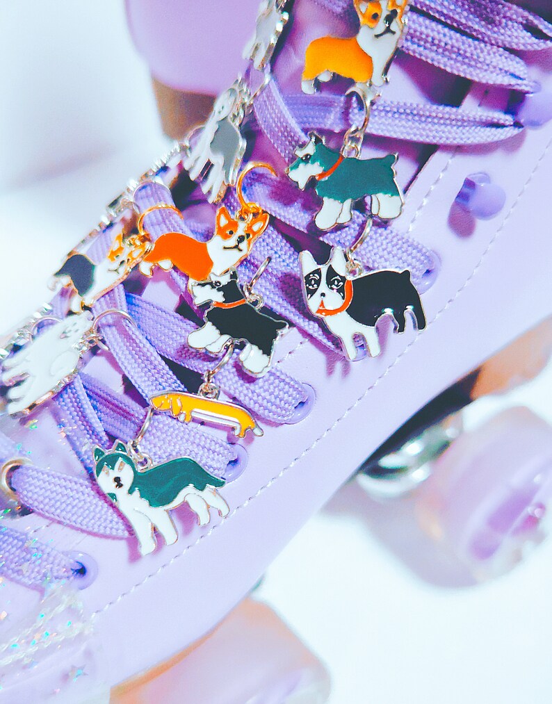 May include: Purple roller skate with colorful dog charms attached to the laces. The charms are of different breeds, including a corgi, a husky, a dachshund, and a terrier.