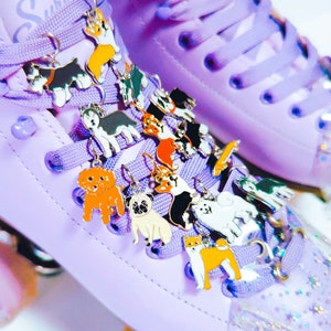 May include: Purple roller skates with a variety of colorful dog charms attached to the laces. The charms are made of metal and feature different dog breeds.