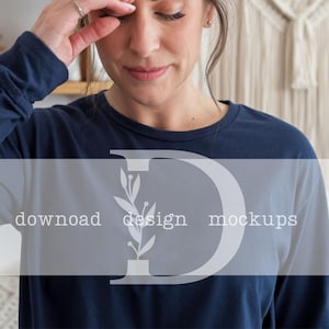 May include: A navy blue long-sleeved shirt with a white floral design and the text "download design mockups".
