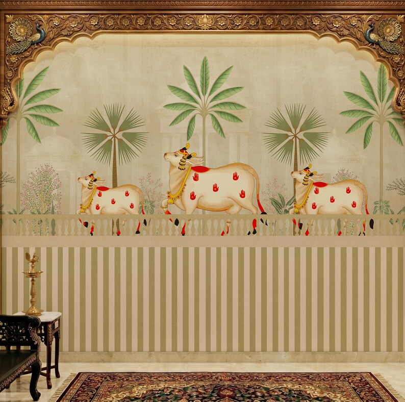 May include: A decorative wall mural featuring three stylized white cows with red handprints, gold accents, and ornate headwear. The cows are positioned above a striped wall, with palm trees and a decorative archway in the background. The mural has a traditional Indian aesthetic.