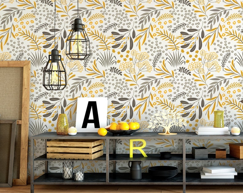 Puede incluir: Una estanter&iacute;a de metal negro con tres estantes, con un fondo blanco con un patr&oacute;n floral amarillo y gris. La estanter&iacute;a est&aacute; decorada con una caja de madera, una peque&ntilde;a planta en maceta y algunos art&iacute;culos decorativos.