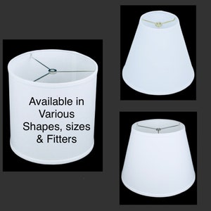 May include: White lamp shades in various shapes and sizes. The image shows three different styles: a cylindrical shade, a tapered shade, and a bell-shaped shade. The text on the image says "Available in Various Shapes, sizes & Fitters."