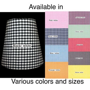 May include: A black and white gingham lampshade with the text "Available in" and a variety of color options listed below: Burgundy/white, Pink/white, Green/white, Navy/white, Red/white, Blue/white, Black/white, Orange/white, and Yellow/white. The text "Various colors and sizes" is at the bottom of the image.