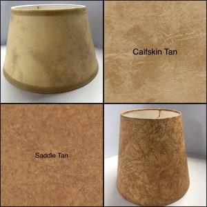 May include: Four lampshades in different shades of tan. The lampshades are made of fabric with a textured surface. The lampshades are labeled "Calfskin Tan" and "Saddle Tan".
