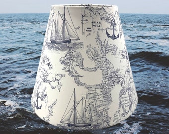 White background with navy nautical ship world map anchor lampshades. Available in various sizes and fitters.