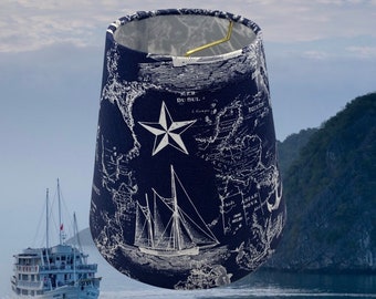 May include: A blue and white lampshade with a nautical map design. The map features a compass rose, a ship, and the text "MER DU SUL."