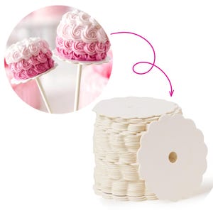 May include: Two cake pops with pink and white frosting, displayed on white sticks and scalloped bases. A stack of white, scalloped-edge paper cake bases with a central hole is also shown, ideal for baking and decorating.