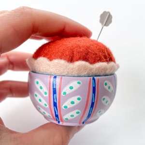 Pincushion - Handmade copper red felt pin cushion with scallop trim and hand painted wood base in light purple, white, navy blue stripes