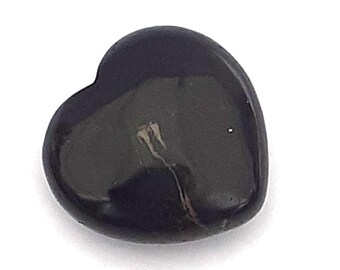 May include: A black heart-shaped polished stone with a light gray vein running through it.