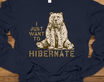 May include: Navy blue long-sleeve shirt with a brown bear illustration and the text "I just want to hibernate".
