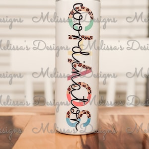 May include: A white stainless steel tumbler with a colorful design featuring a leopard print, circles, and the word "Mom" in black script.